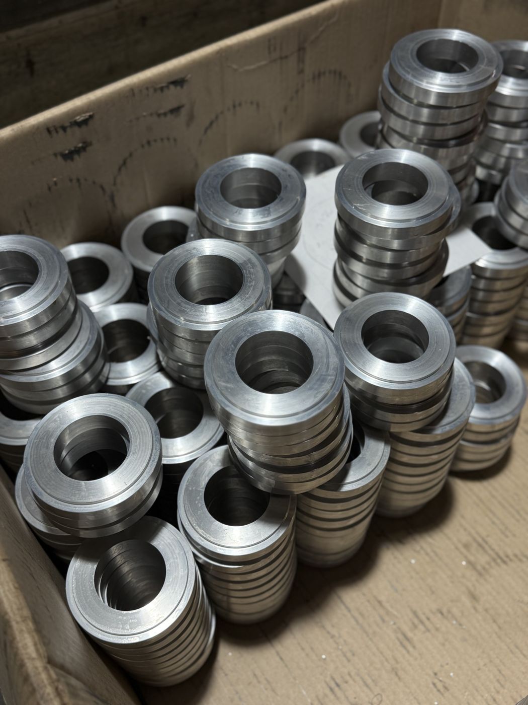 A box of machined aluminum rings