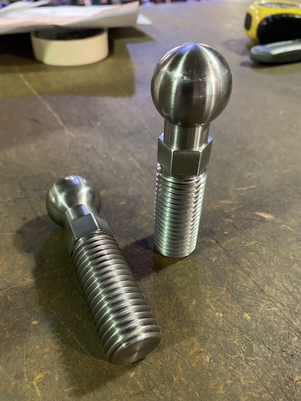 Two machined ball studs with hex and threads