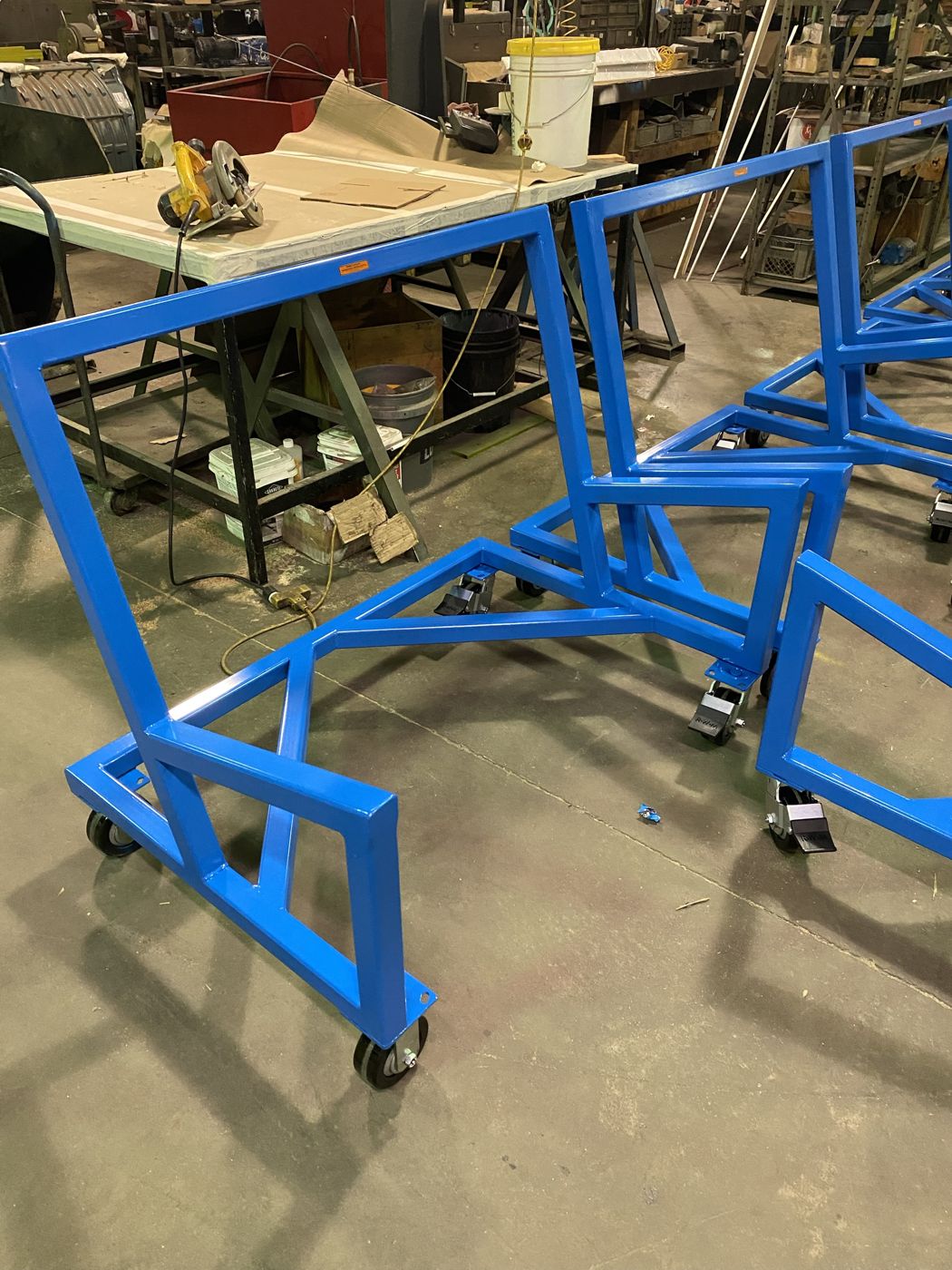 Welded steel frame carts on casters, finished in blue