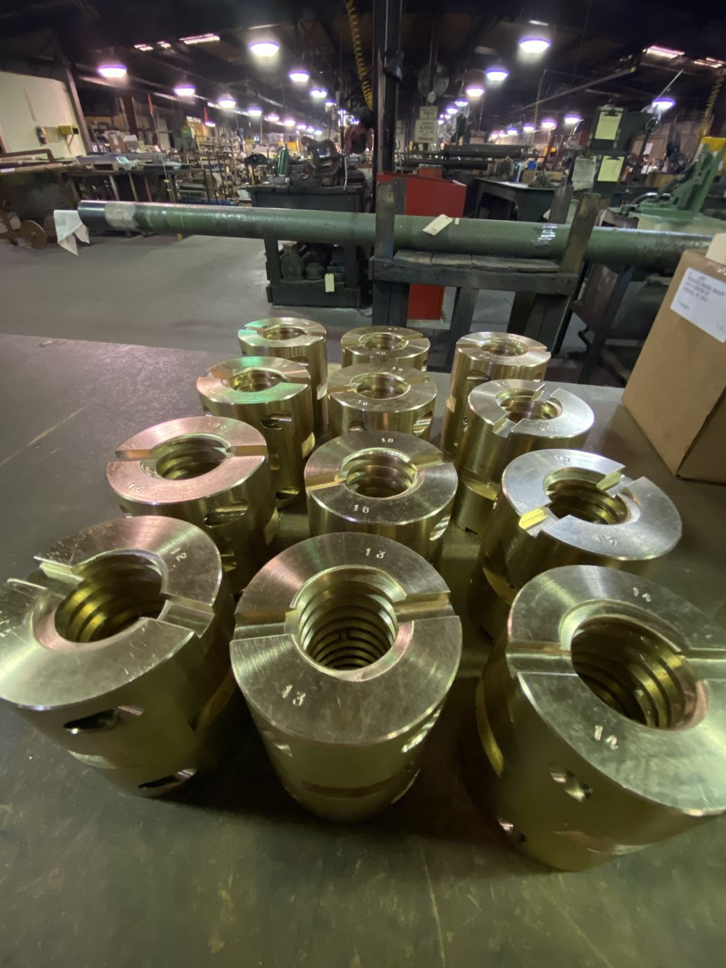 Threaded bronze nuts on a bench in the shop