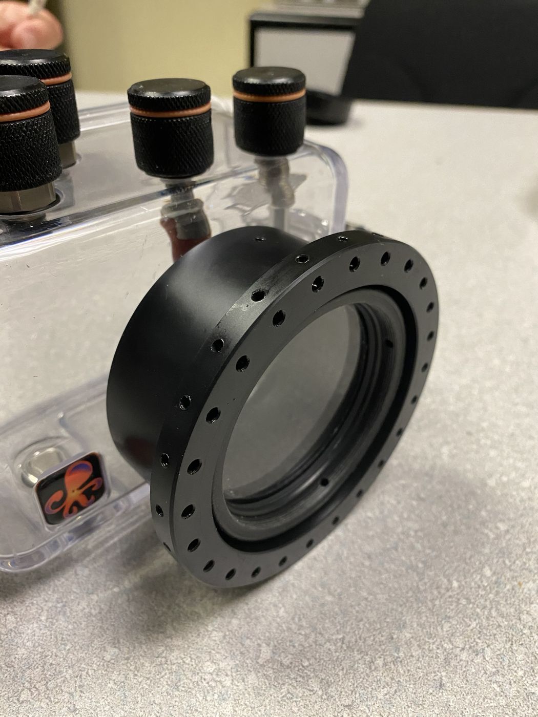 A custom machined port ring on an underwater camera housing