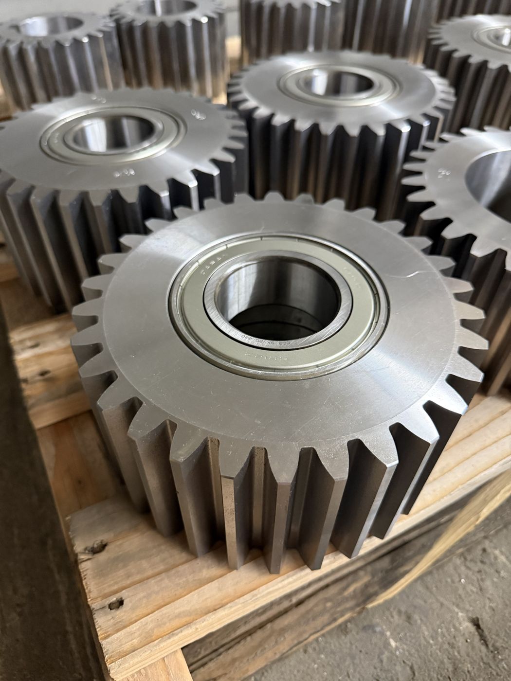 Machined steel spur gears with bearings pressed in