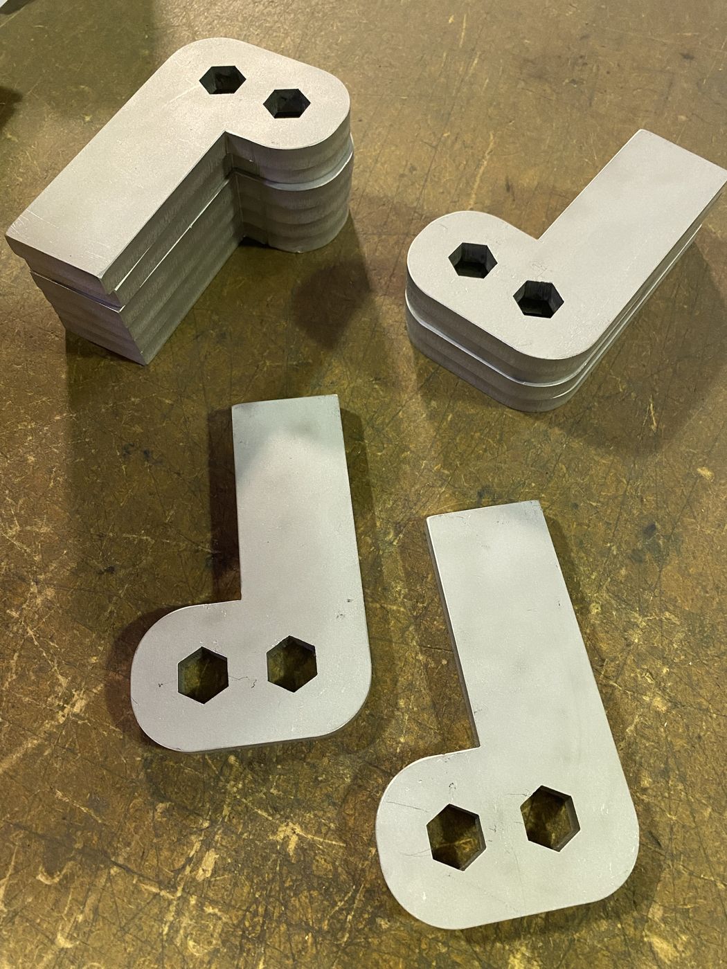 Steel plate brackets with hex-shaped cutouts