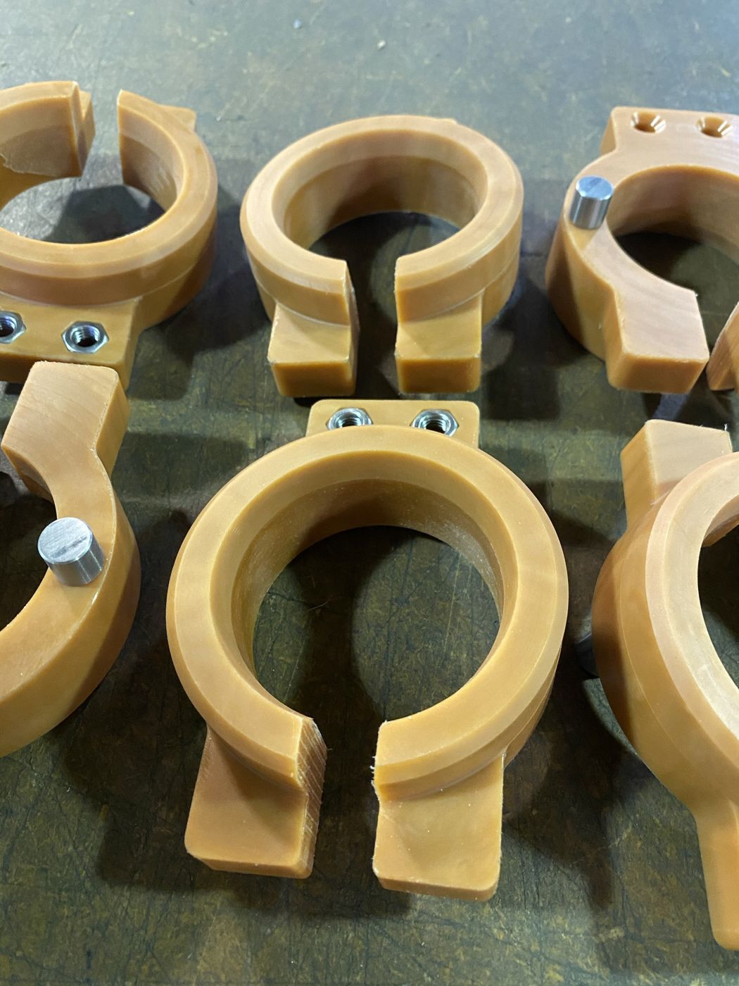 Tan plastic split clamps with steel inserts and pins