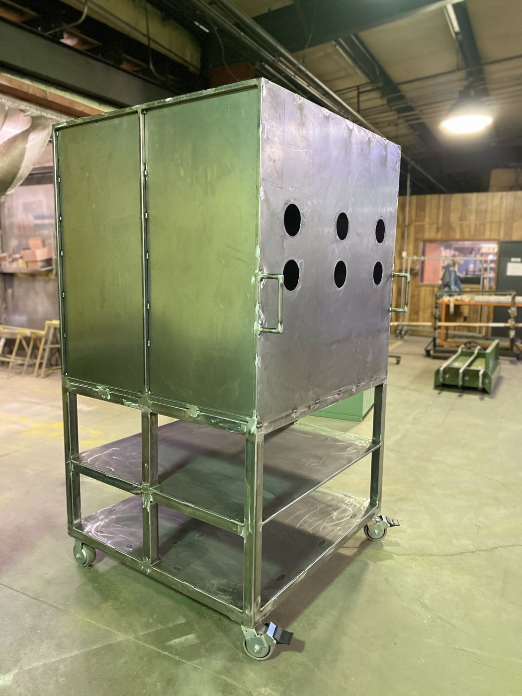 A welded steel cabinet cart on casters