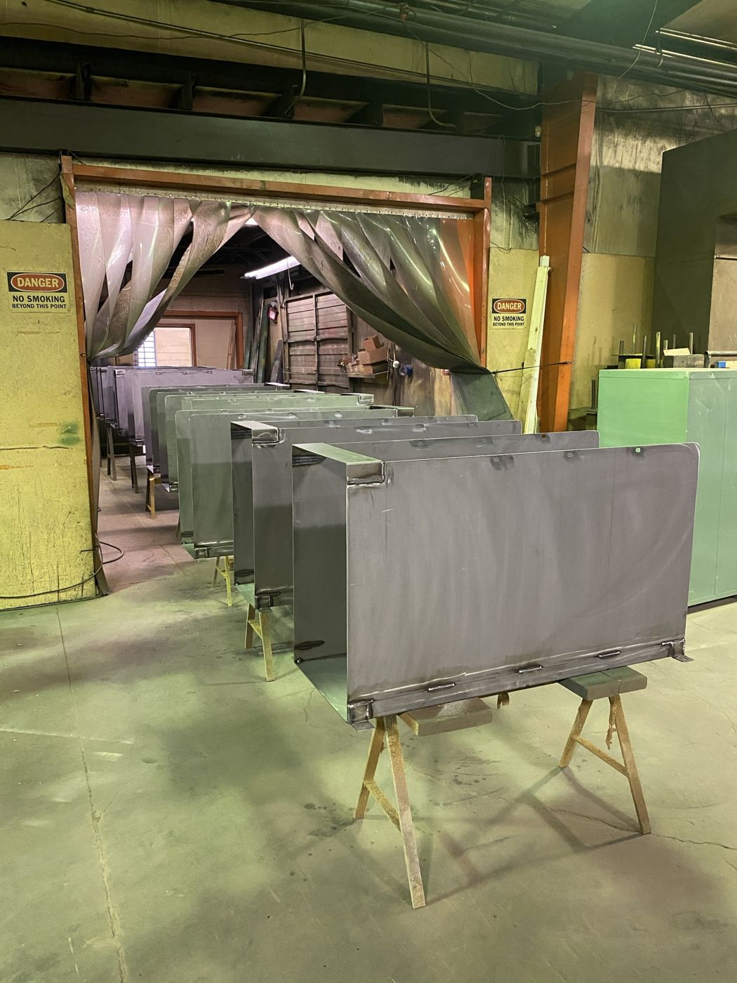 Welded sheet metal enclosures on sawhorses in the shop
