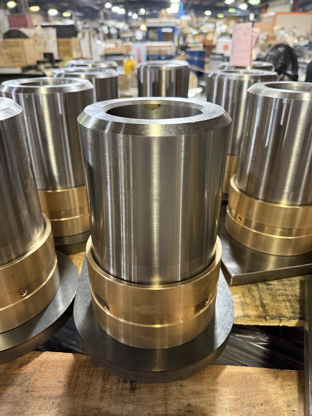 Large turned steel sleeves with bronze collars