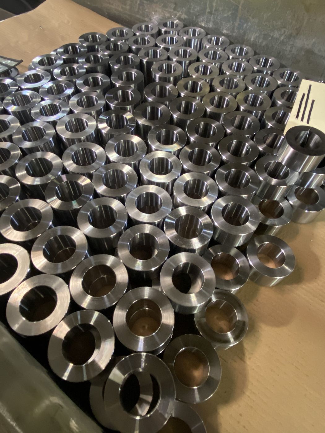 A box of machined steel spacers