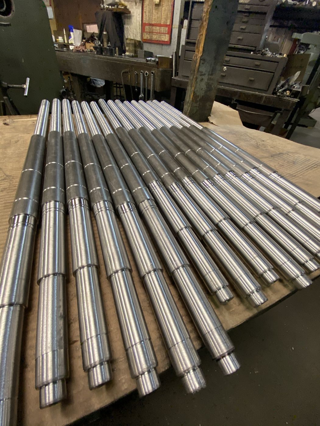 A row of precision stepped steel shafts