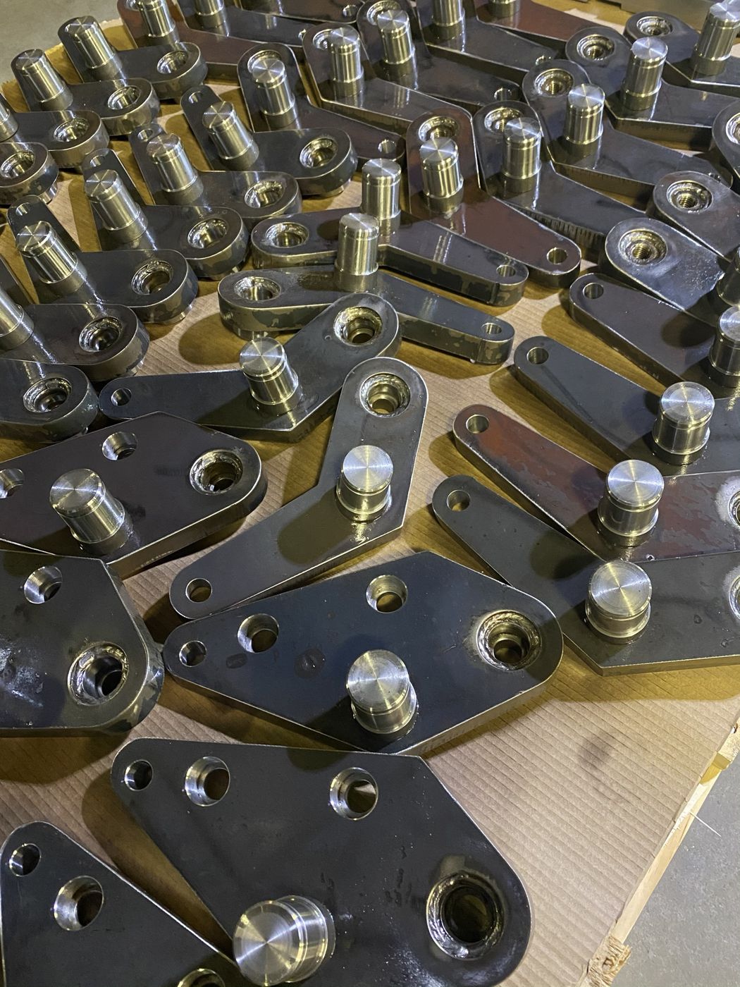 Welded steel arms with machined pins